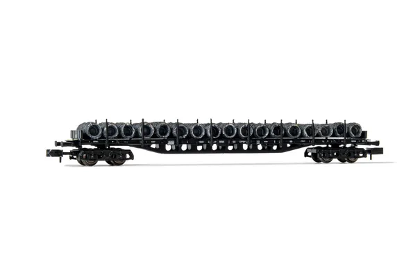 DB, 4-axle flat wagon with stakes Sgjs 716, black livery, loaded with wire coils, period IV